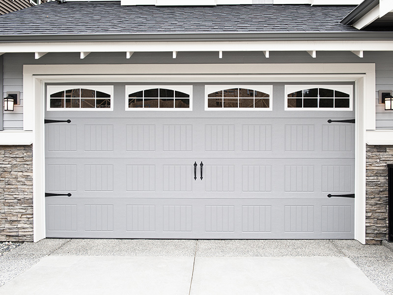 residential property exteriors with grey garage door installed with windows baldwin mi