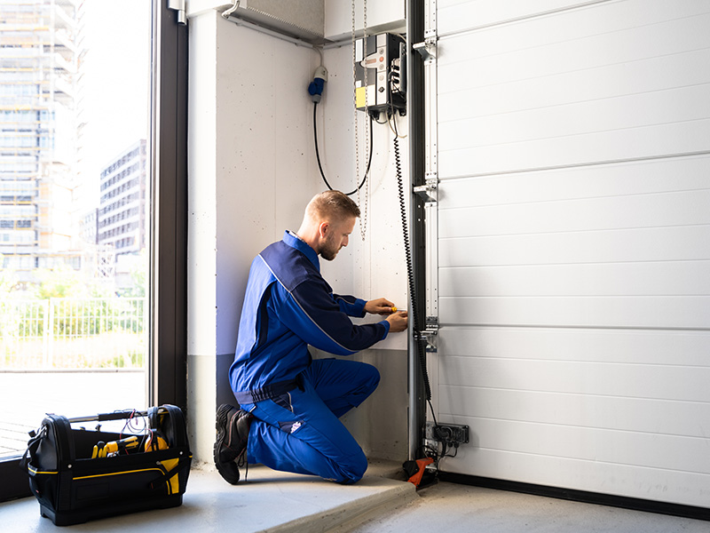 technician installing new garage door at property interiors bailey mi